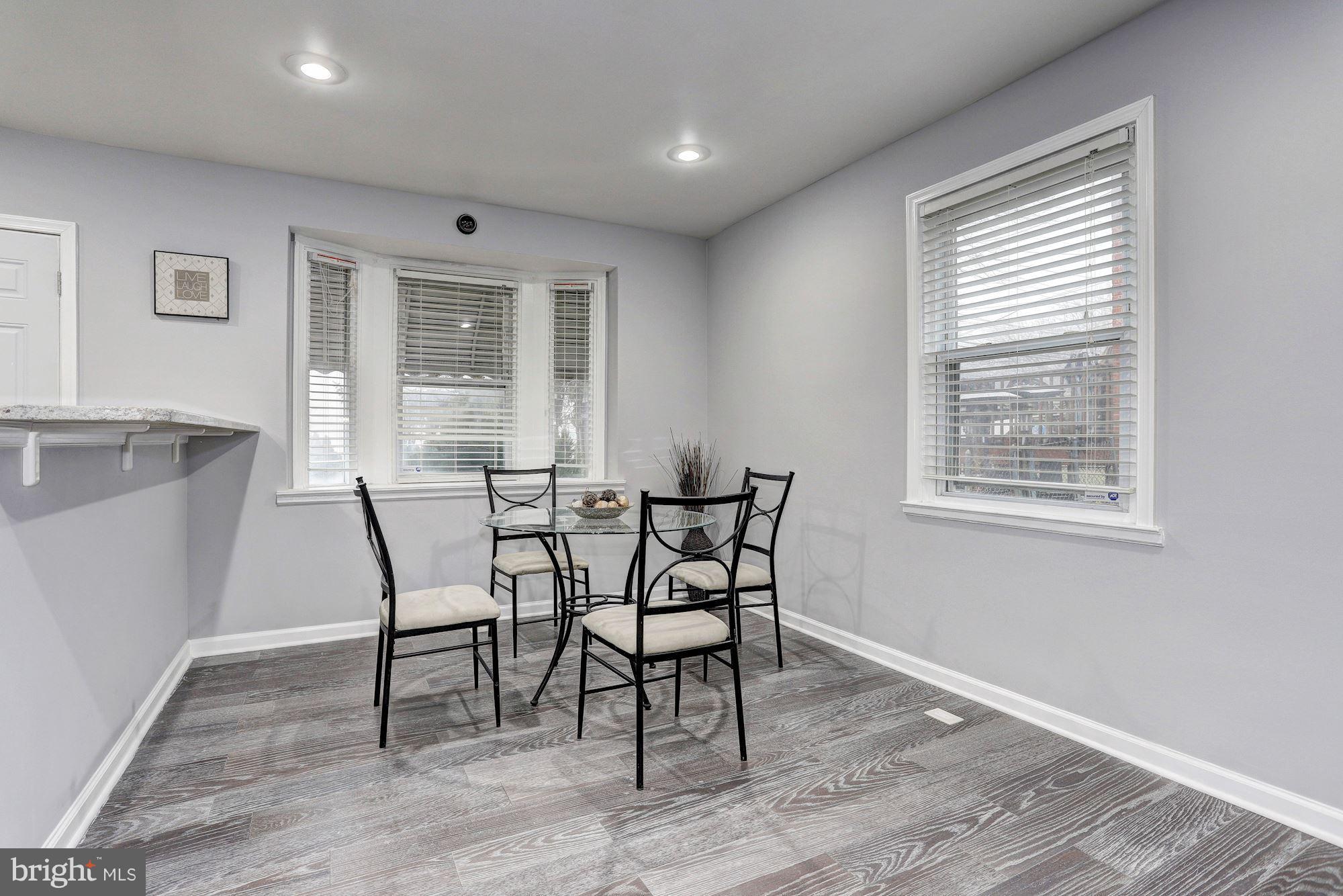 4510 Marble Hall Road Baltimore, MD 21239 - Photo 6 of 24 a dining room with wooden floor and a window