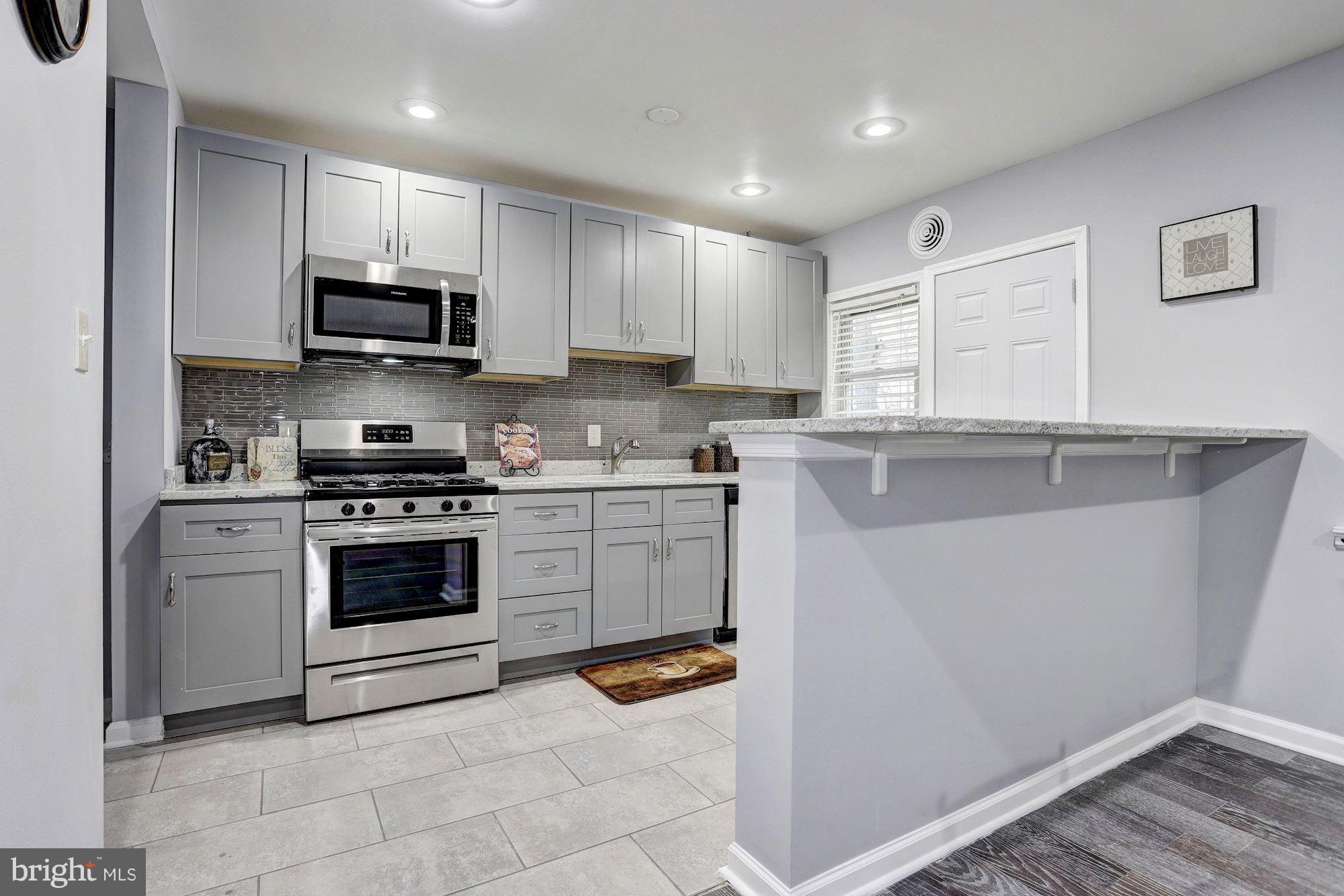 4510 Marble Hall Road Baltimore, MD 21239 - Photo 8 of 24 a kitchen with stainless steel appliances granite countertop a sink and a stove