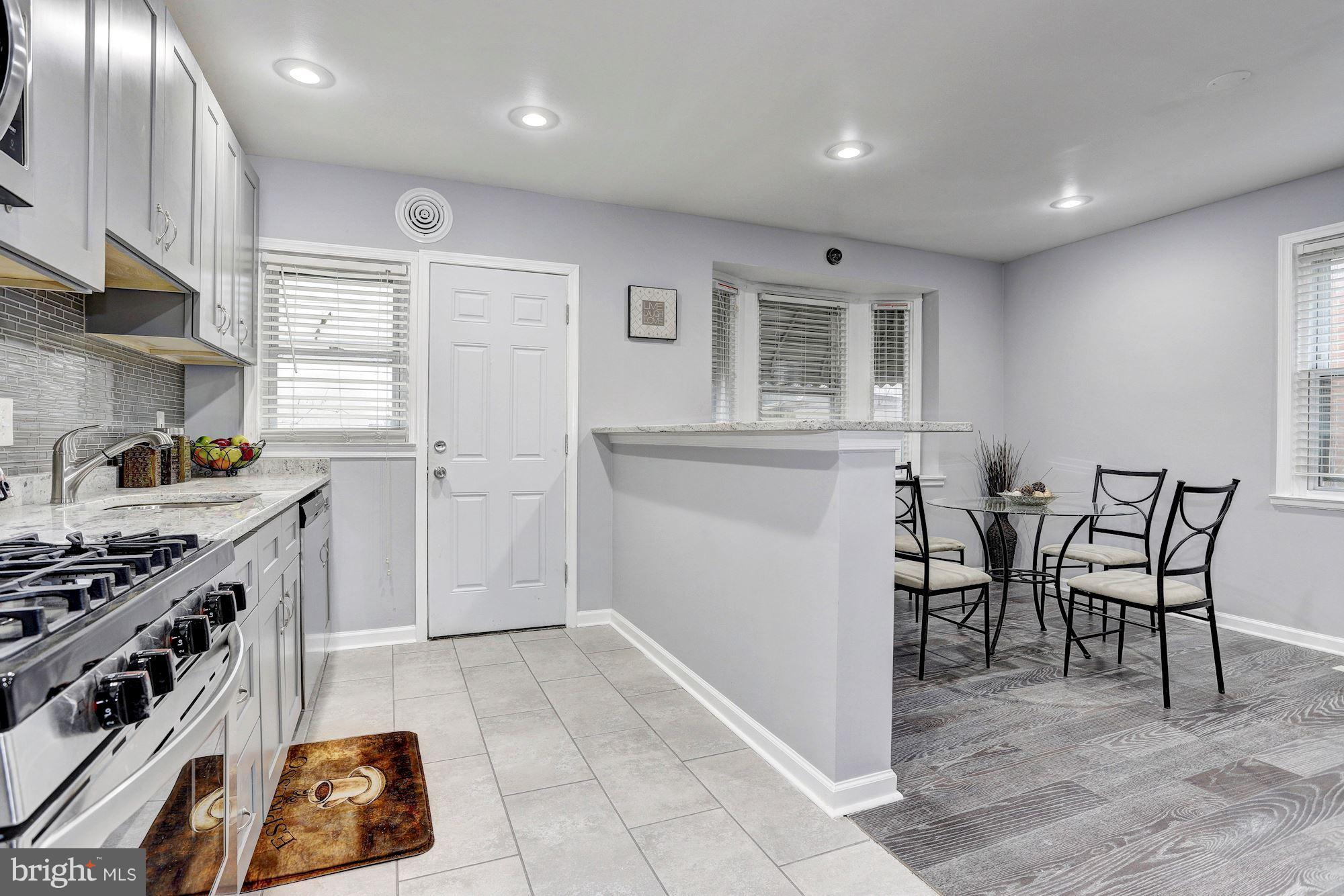 4510 Marble Hall Road Baltimore, MD 21239 - Photo 10 of 24 a kitchen with cabinets and chairs