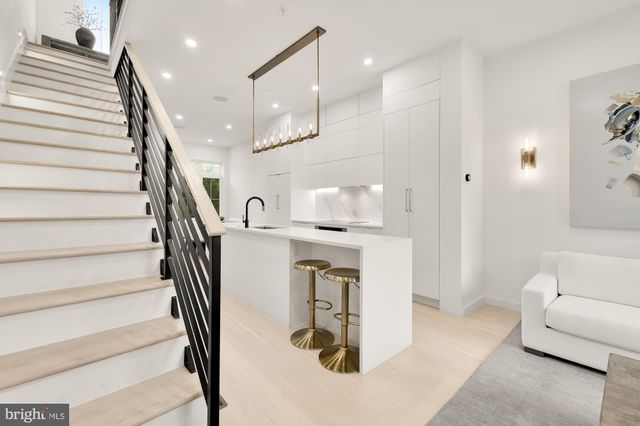 a view of a dining room with furniture and a potted plant
