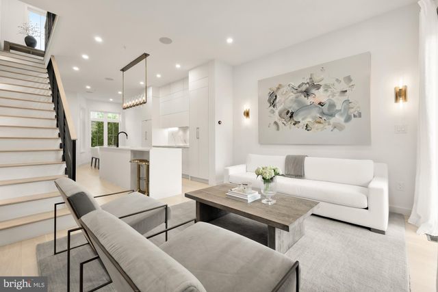 a living room with furniture and kitchen view