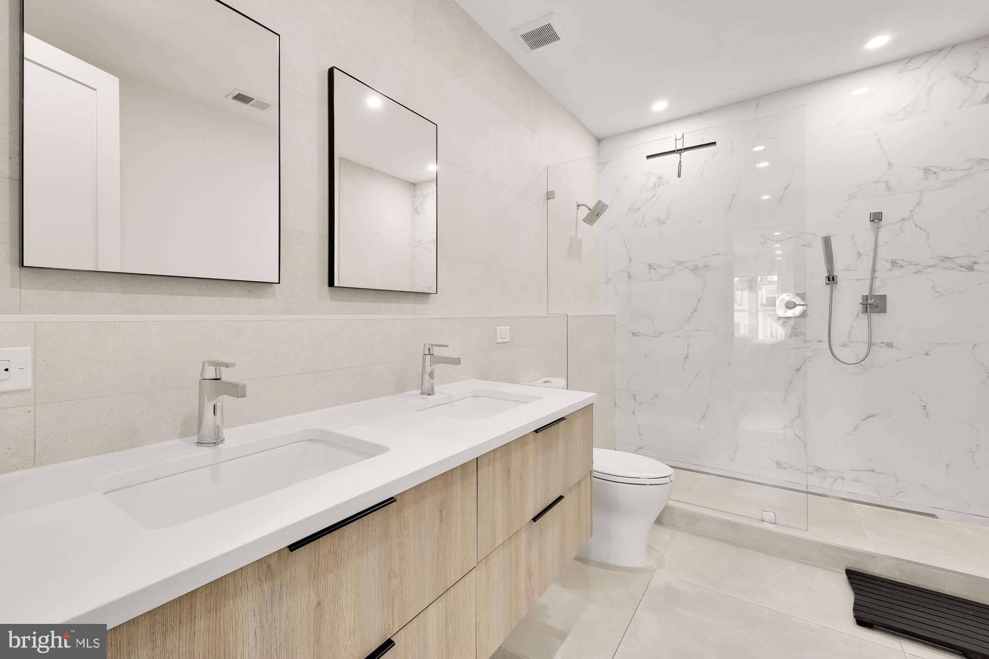 146 S Street Northwest, Unit B Washington, DC 20001 - Photo 29 of 51 a bathroom with a sink a toilet and shower