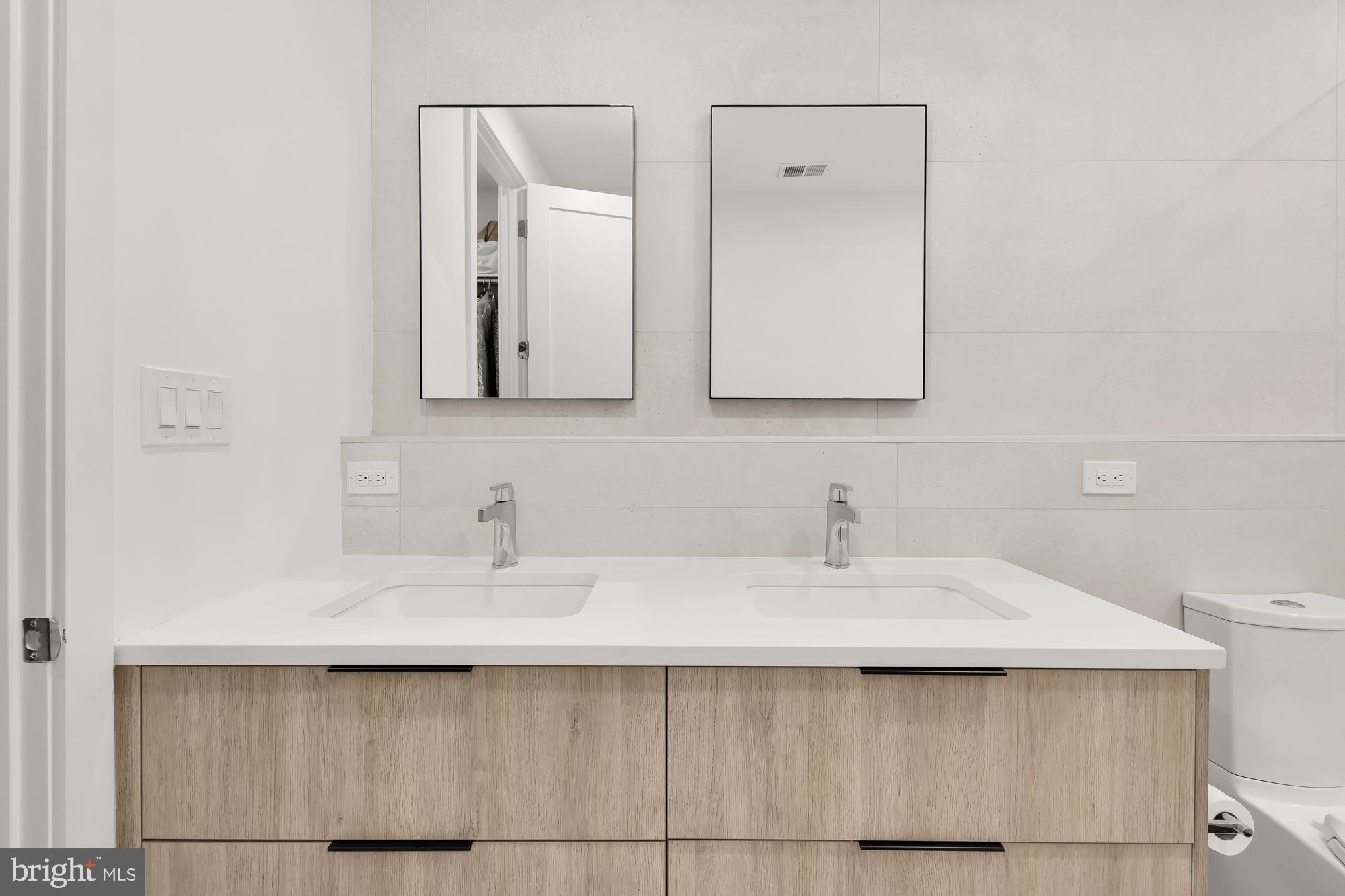 146 S Street Northwest, Unit B Washington, DC 20001 - Photo 31 of 51 a bathroom with a sink and a mirror