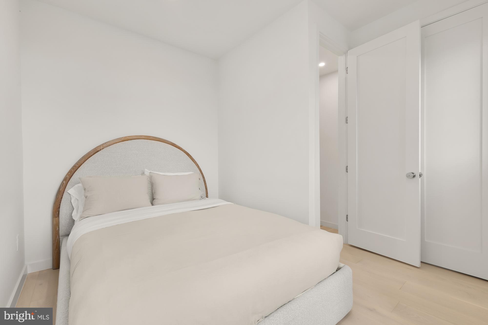 146 S Street Northwest, Unit B Washington, DC 20001 - Photo 34 of 51 a large bed sitting in a room next to a window