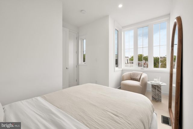 a living room with furniture and large windows