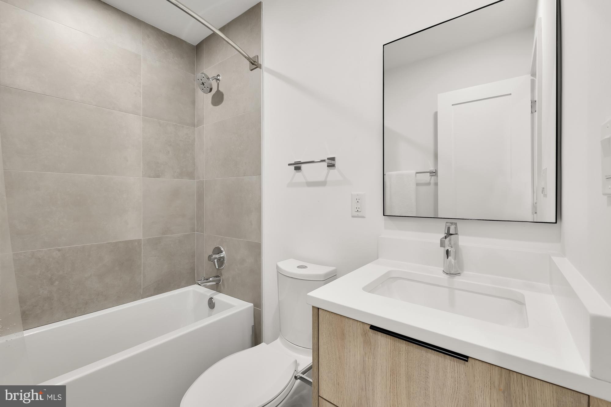 146 S Street Northwest, Unit B Washington, DC 20001 - Photo 45 of 51 a bathroom with a granite countertop sink a toilet and shower
