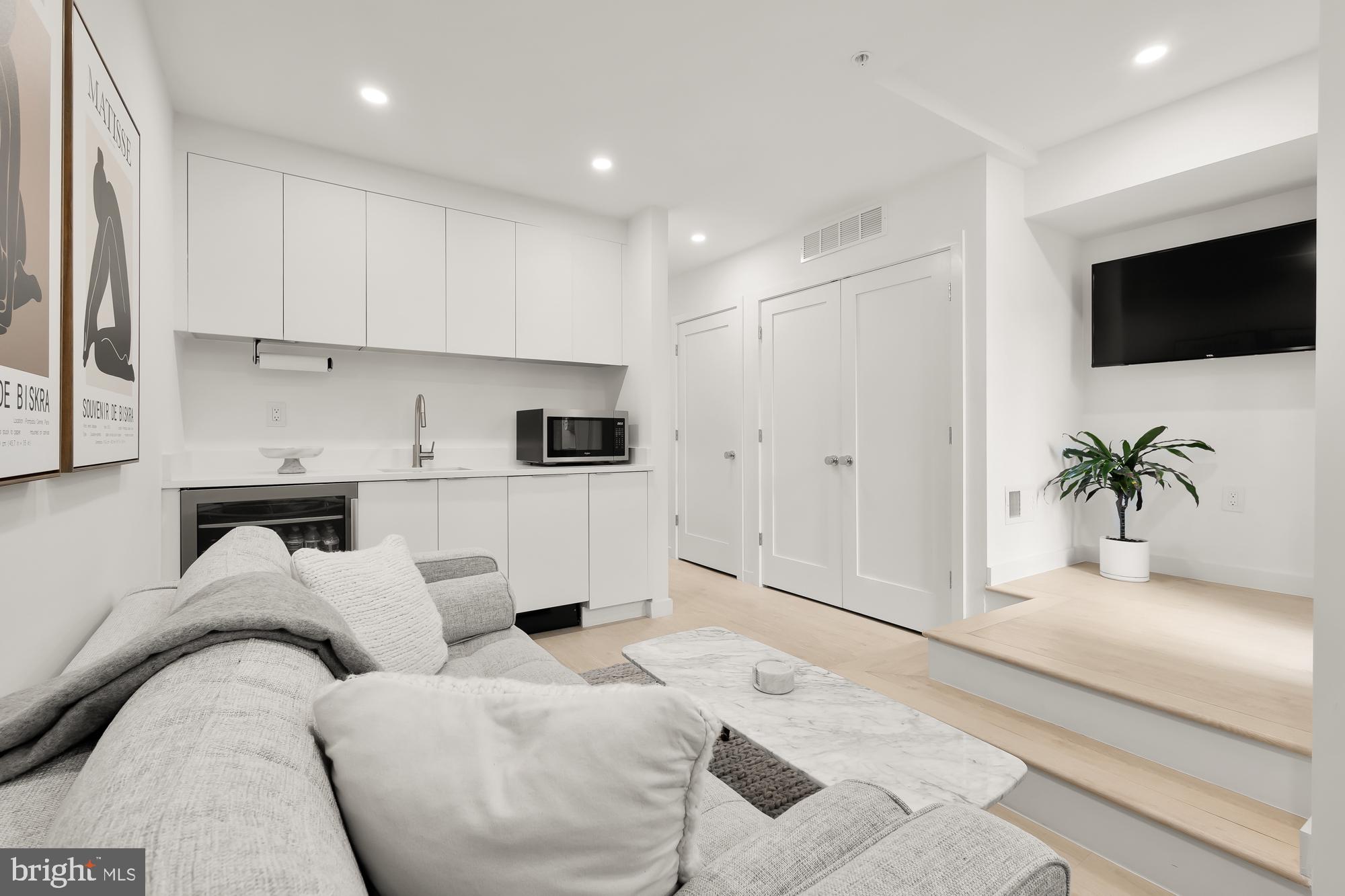 146 S Street Northwest, Unit B Washington, DC 20001 - Photo 48 of 51 a living room with furniture and a flat screen tv