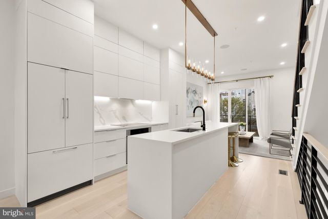 a view of kitchen with sink microwave and stove