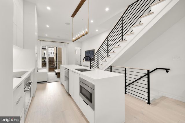 a kitchen with a sink and a stove top oven