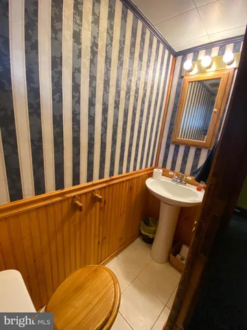 a bathroom with a toilet and a mirror