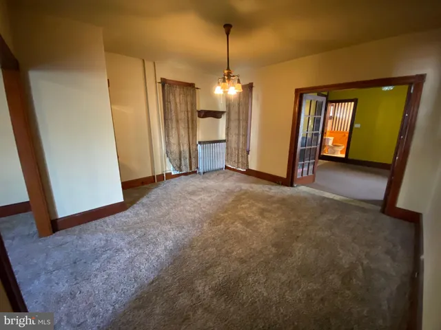 a view of a hallway with closet and bathroom