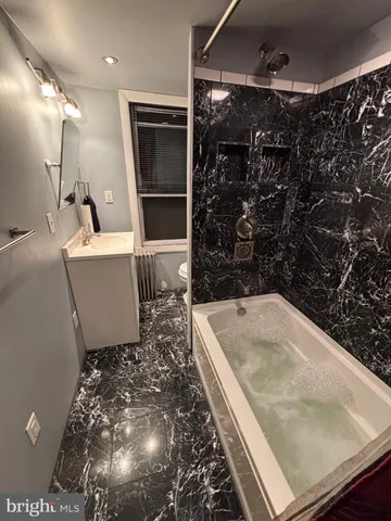 a bathroom with a bathtub and shower