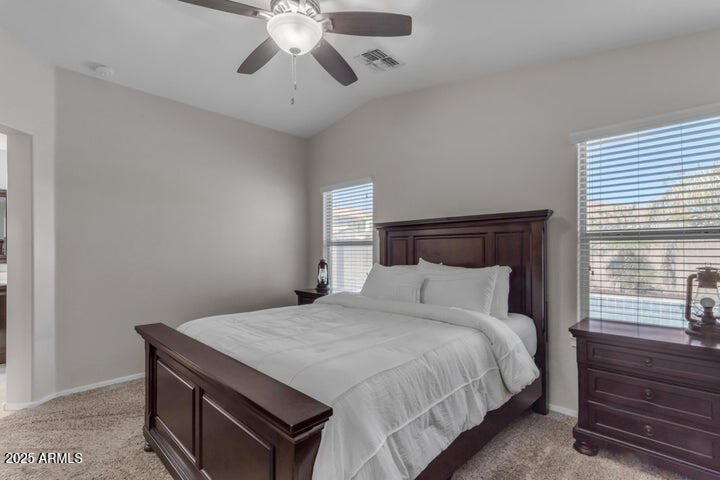 2220 East Stacey Road Gilbert, AZ 85298 - Photo 13 of 54 a bedroom with a bed and a chandelier