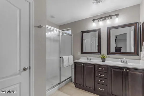 a bathroom with a double vanity sink and mirror
