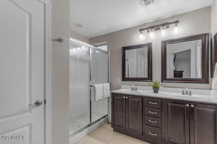 2220 East Stacey Road Gilbert, AZ 85298 - Photo 15 of 54 a bathroom with a double vanity sink and mirror