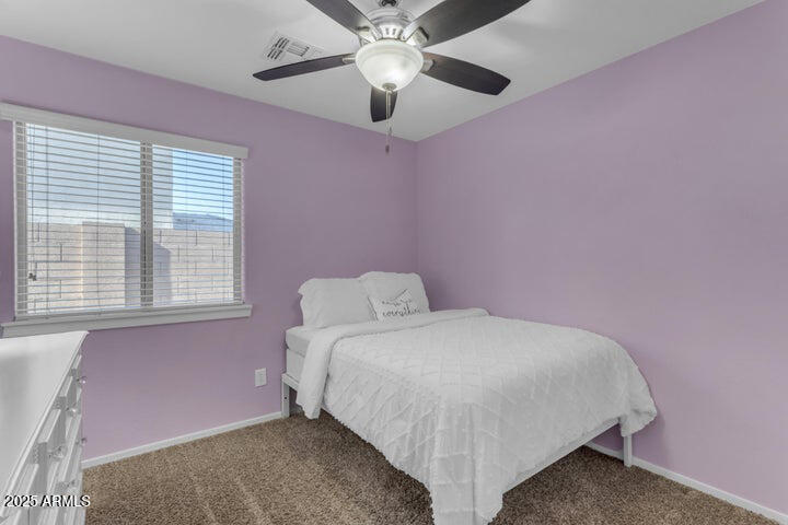 2220 East Stacey Road Gilbert, AZ 85298 - Photo 20 of 54 a bedroom with a bed and a chandelier fan