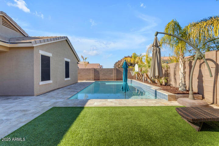 2220 East Stacey Road Gilbert, AZ 85298 - Photo 23 of 54 a backyard of a house with wooden floor and fence
