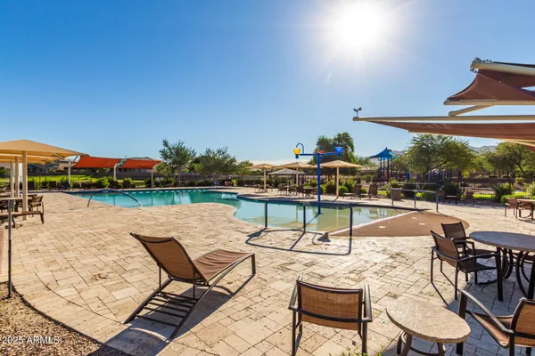 a view of a white house with a small yard and potted plants
