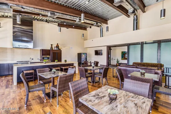 a view of a patio with table and chairs under an umbrella