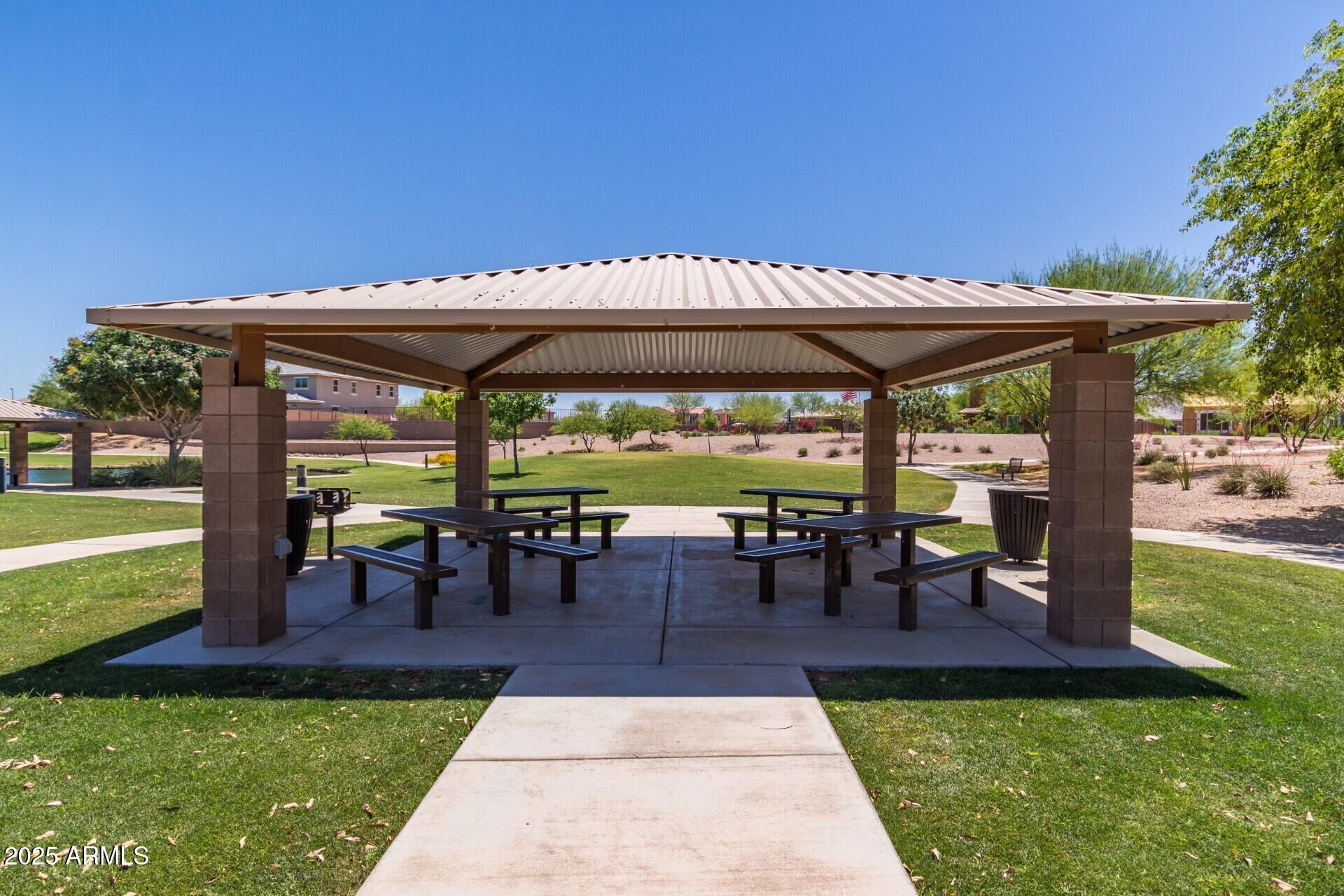 2220 East Stacey Road Gilbert, AZ 85298 - Photo 39 of 54 a view of a patio with table and chairs under an umbrella