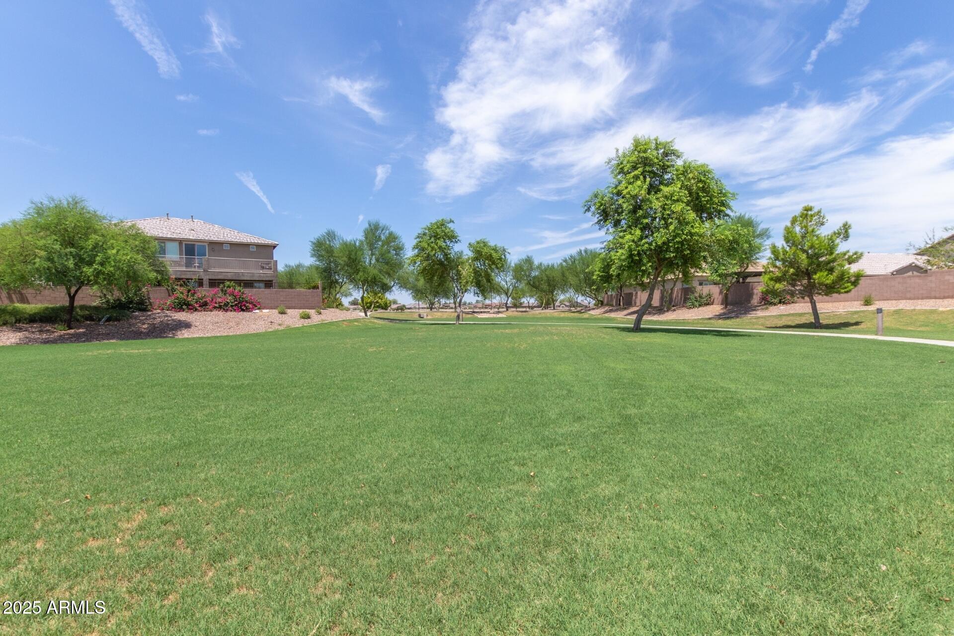 2220 East Stacey Road Gilbert, AZ 85298 - Photo 47 of 54 a view of a garden with a building in the background