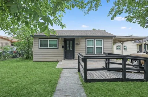 a view of a house with a yard and sitting area