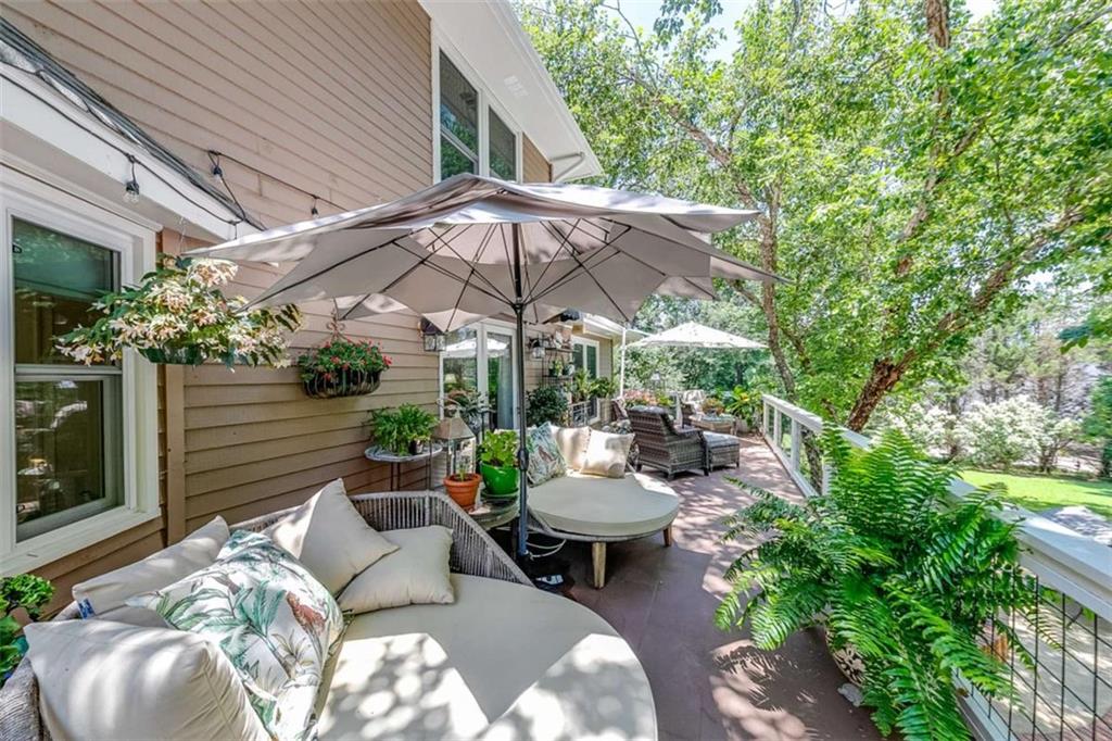 6180 Old Jefferson Road Athens, GA 30607 - Photo 22 of 95 a view of a patio with couches table and chairs under an umbrella with a barbeque