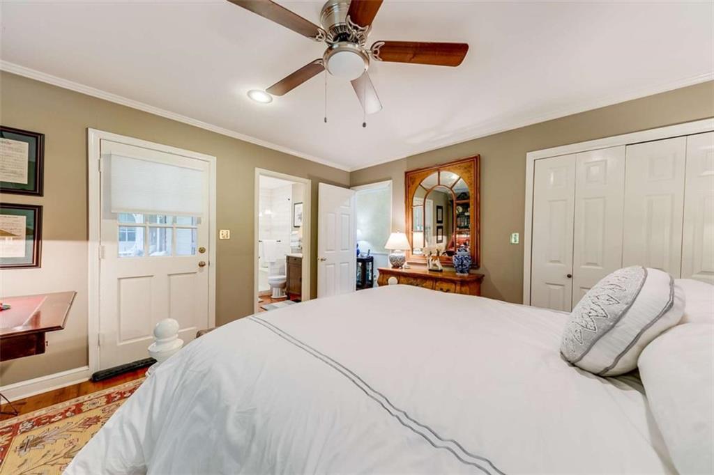 6180 Old Jefferson Road Athens, GA 30607 - Photo 50 of 95 a bedroom with a large bed and a chandelier