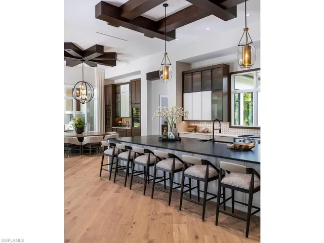 a view of a dining room with furniture and a chandelier