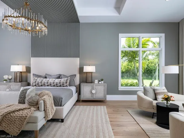 a bedroom with furniture and a large window