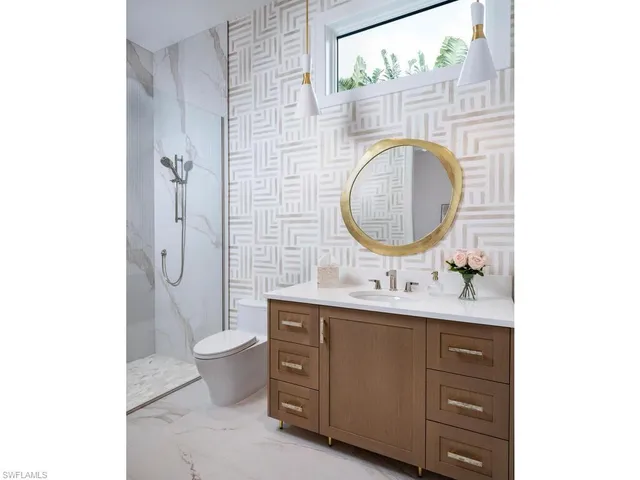 a spacious bedroom with a bed and a dresser in it