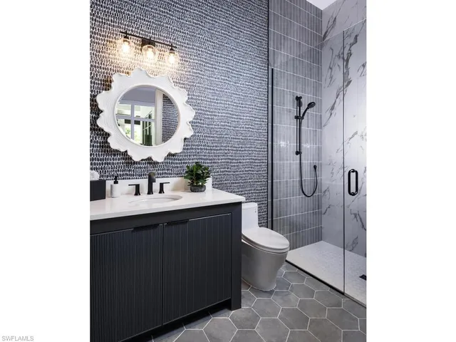 a living room with furniture a chandelier and a flat screen tv