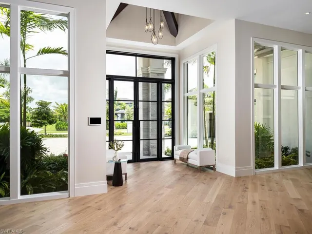 a view of an entryway with wooden floor and windows