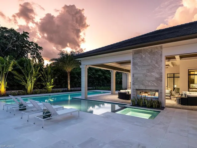 a view of a swimming pool with outdoor seating