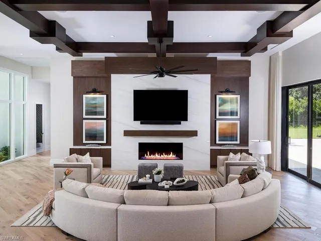 a living room with furniture a fireplace and a flat screen tv