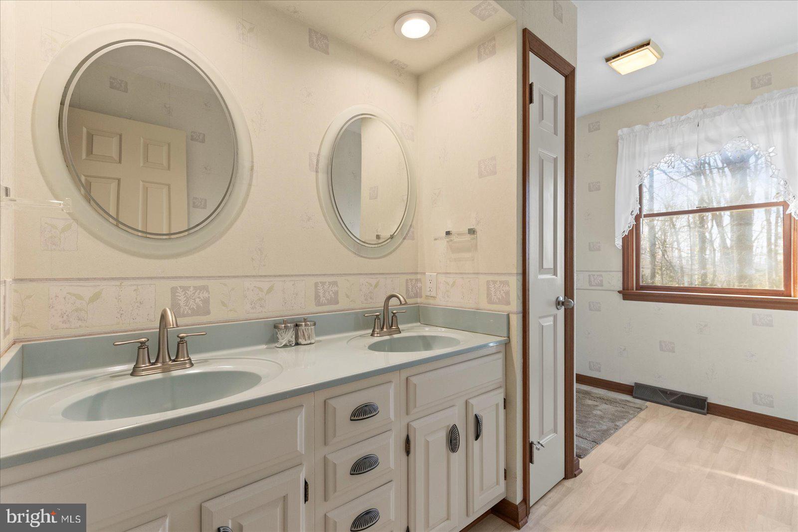 437 Valley View Drive Hanover, PA 17331 - Photo 27 of 40 a bathroom with a double vanity sink and a mirror