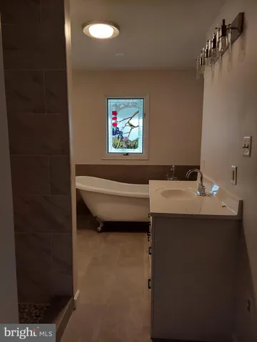 a bathroom with a sink a toilet and a tub