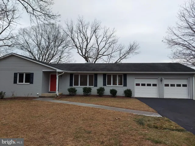 a kitchen with stainless steel appliances granite countertop a refrigerator a sink dishwasher a stove and a sink with wooden cabinets
