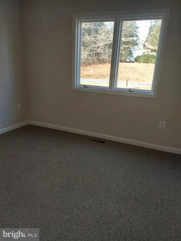 a view of room with window and air conditioner