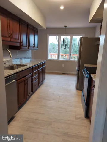 a view of room with window and wooden floor