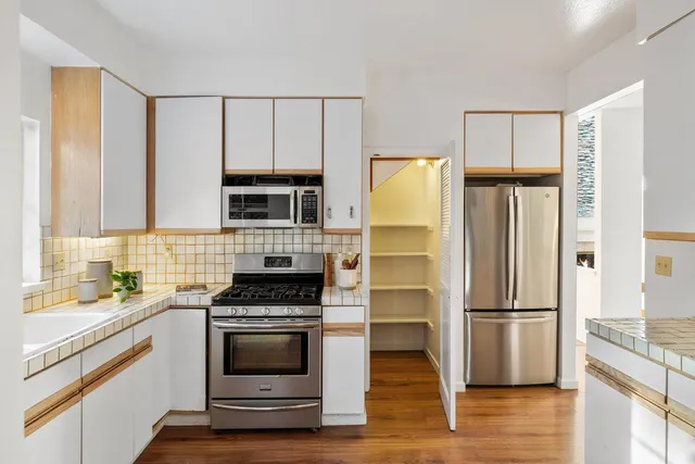 a kitchen with a refrigerator stove and microwave