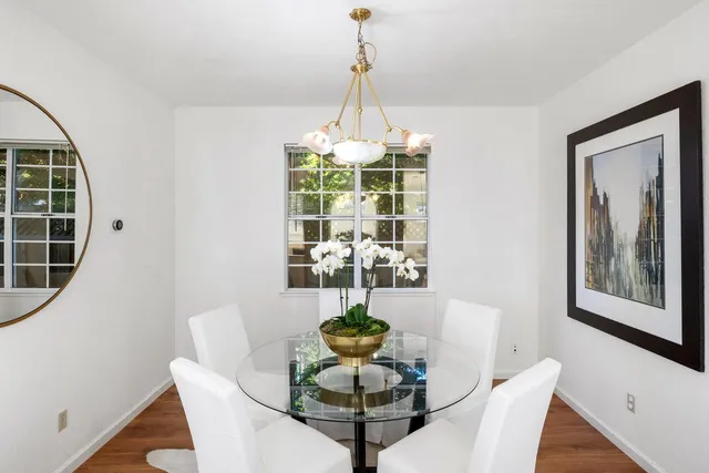 a dining room with furniture and window