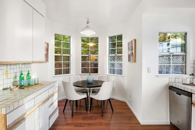 a view of a dining room with furniture and windows