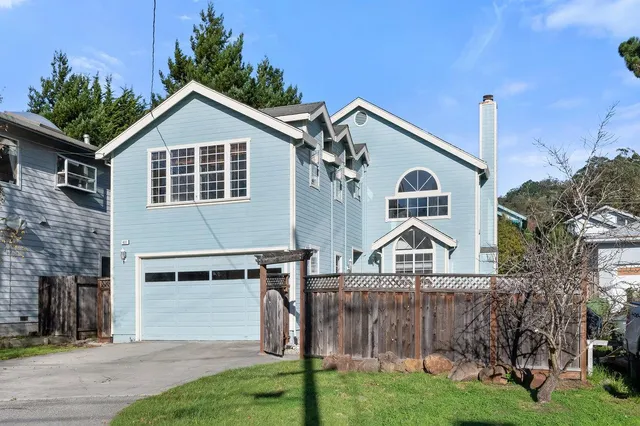 a view of a house with a yard and plants