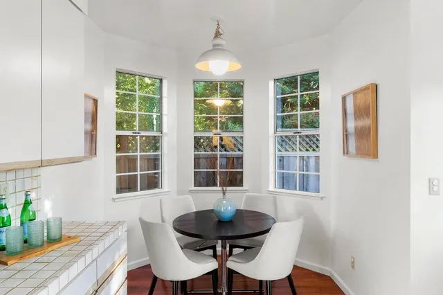 a view of a dining room with furniture and windows