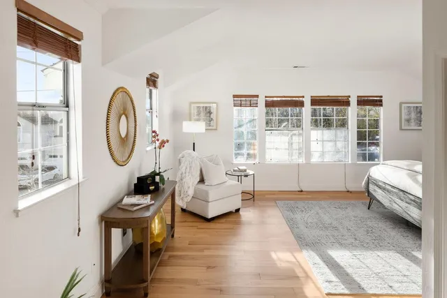 a bedroom with furniture and a large window