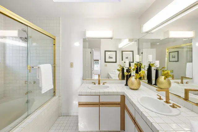 a bathroom with a tub sink and mirror