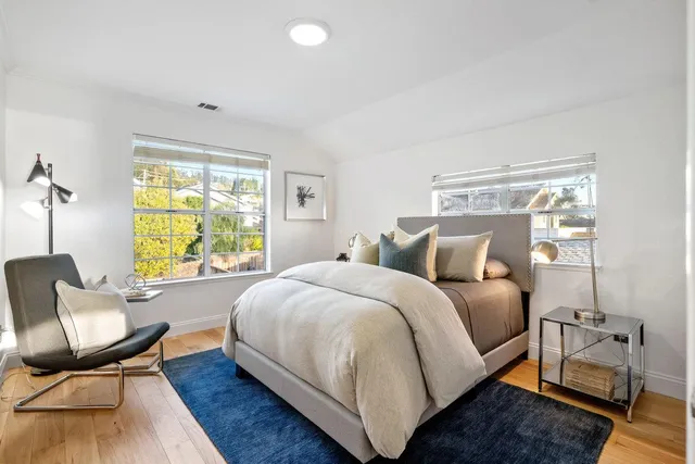 a bed room with a bed and a chair