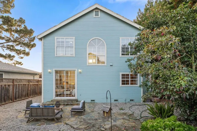 a backyard of a house with yard and outdoor seating