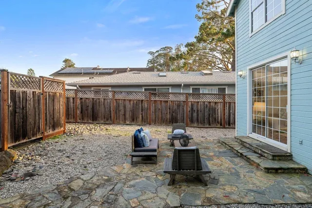 a backyard view with a seating space